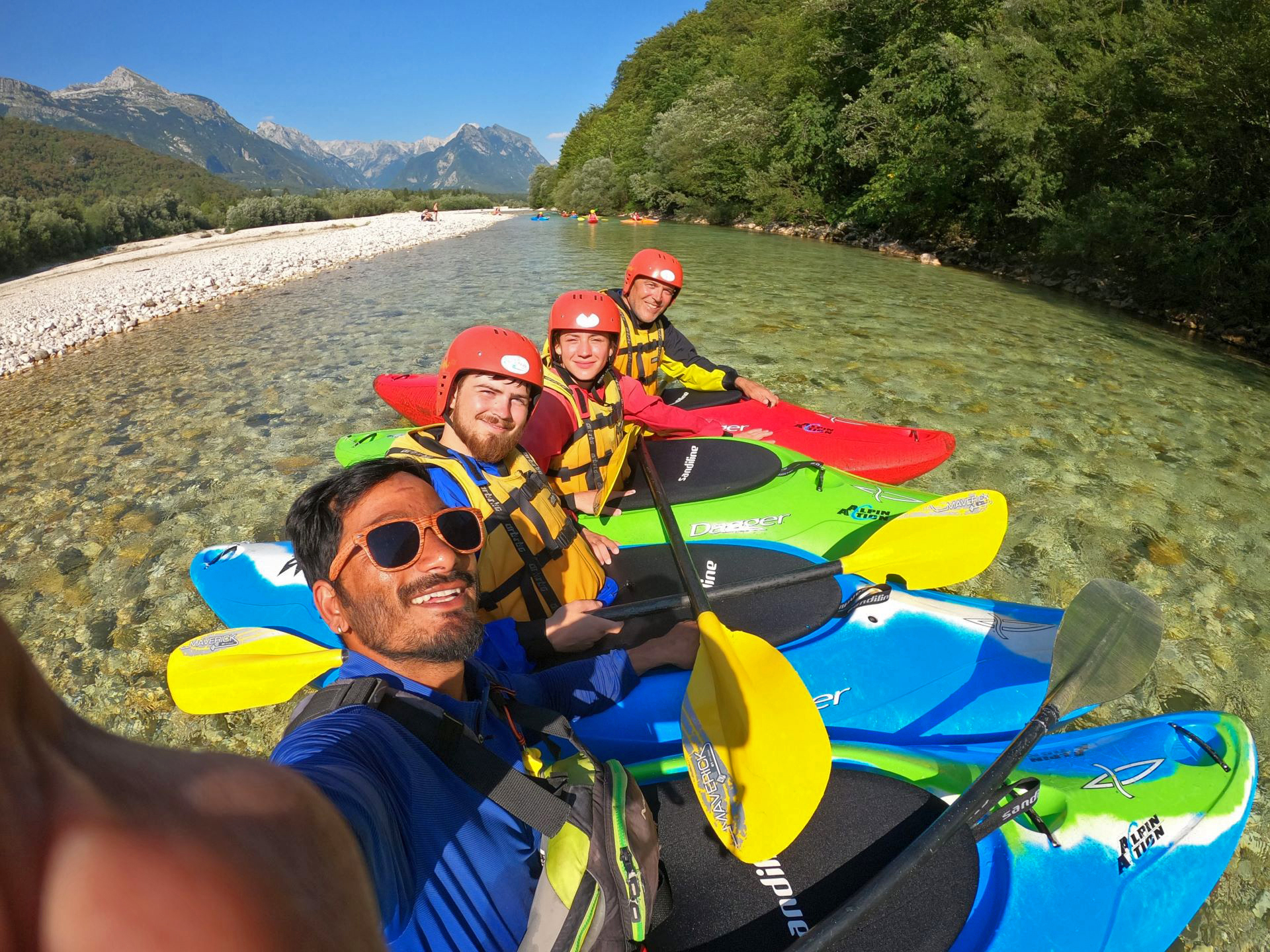 Friends enjoying a private kayaking adventure on the Soča River in Soča Valley