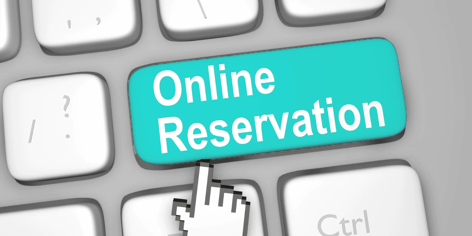 Close-up of a computer keyboard where the Enter key is replaced with a "Book Now" button.