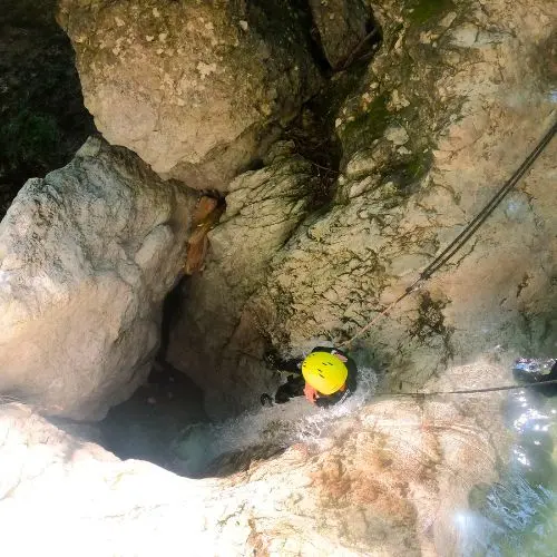 A guest rappelling or sliding through the famous 