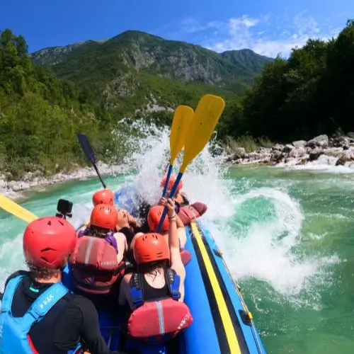 Whitewater rafting adventure on the emerald Soča River rapids in Triglav National Park, Slovenia.