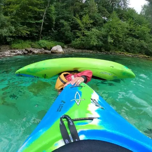 A kayak instructor teaching a guest the 